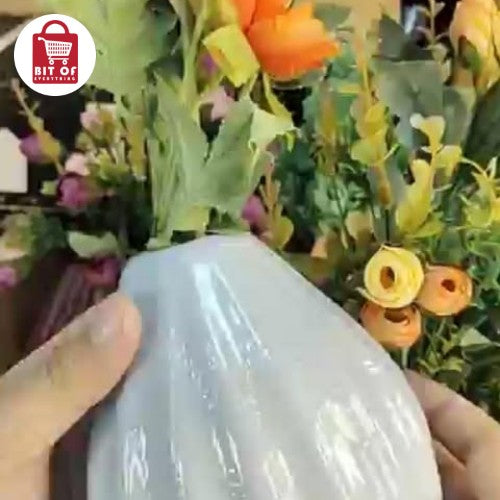 Ribbed Grey Ceramic Vase with Orange Marigolds and Ranunculi Flowers